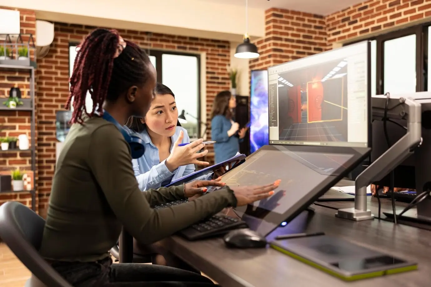 Women of diverse backgrounds working on graphic designs