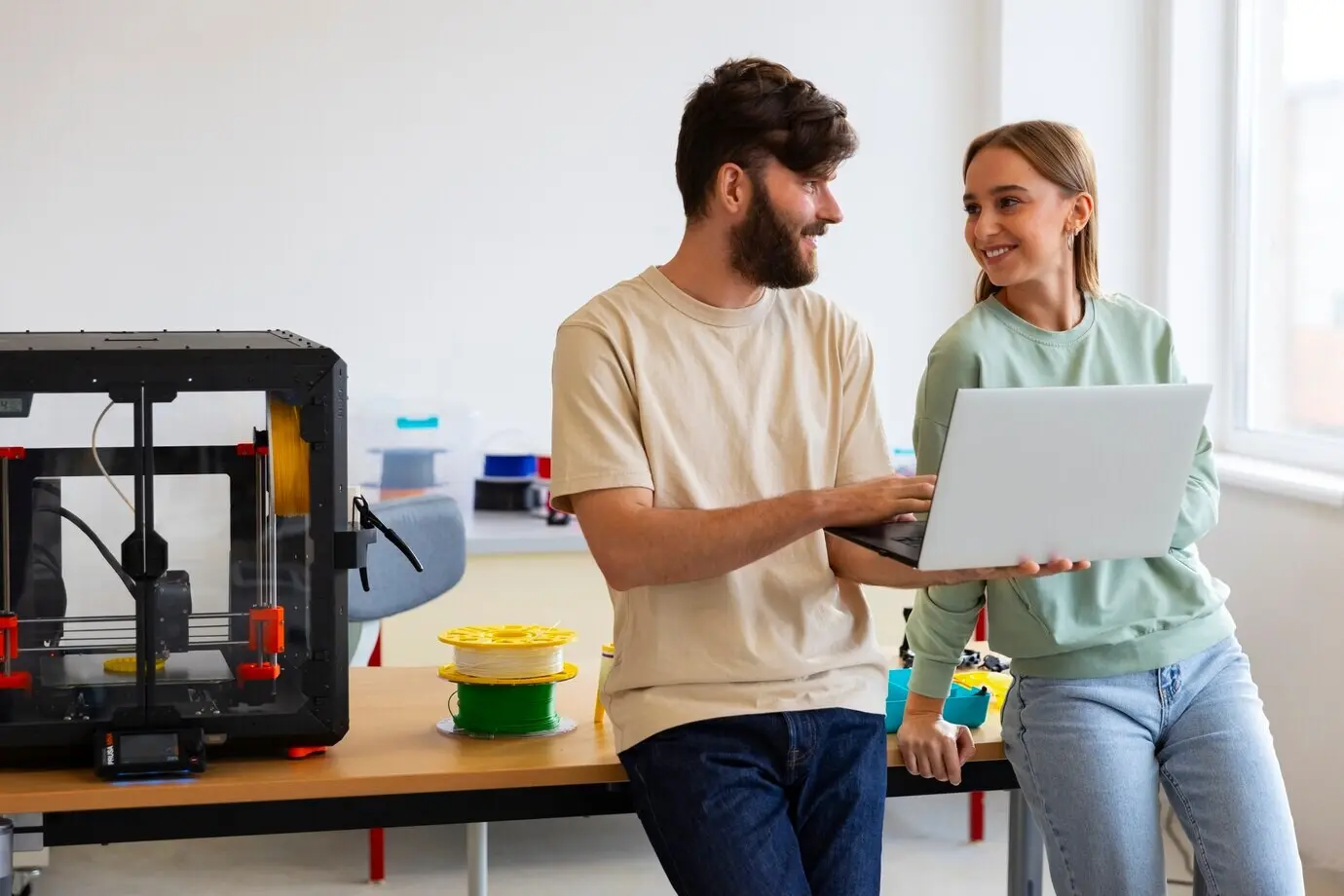 Designers operating a 3D printer