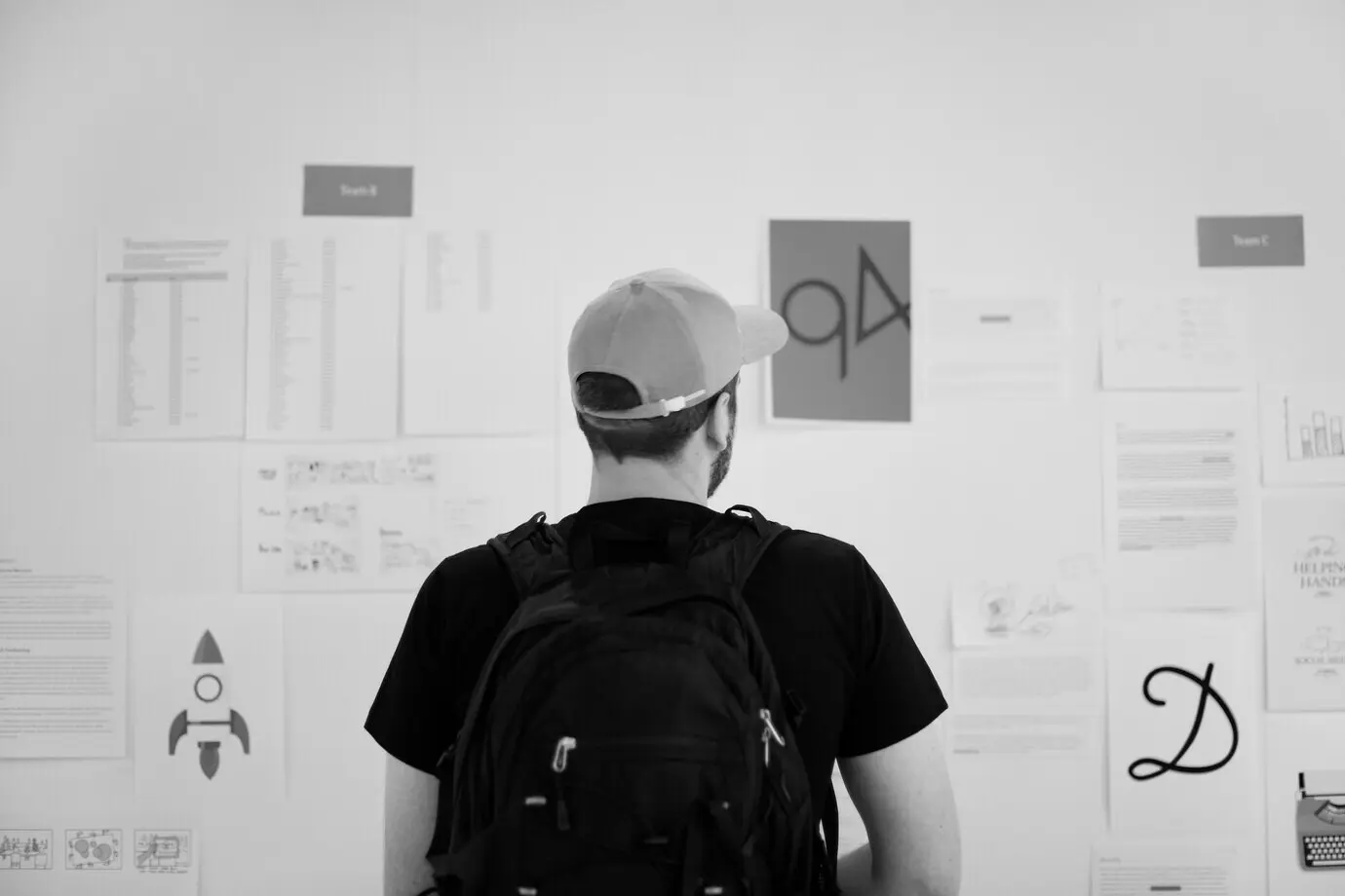 Startup business people thoughtfully looking at information on a strategy board.